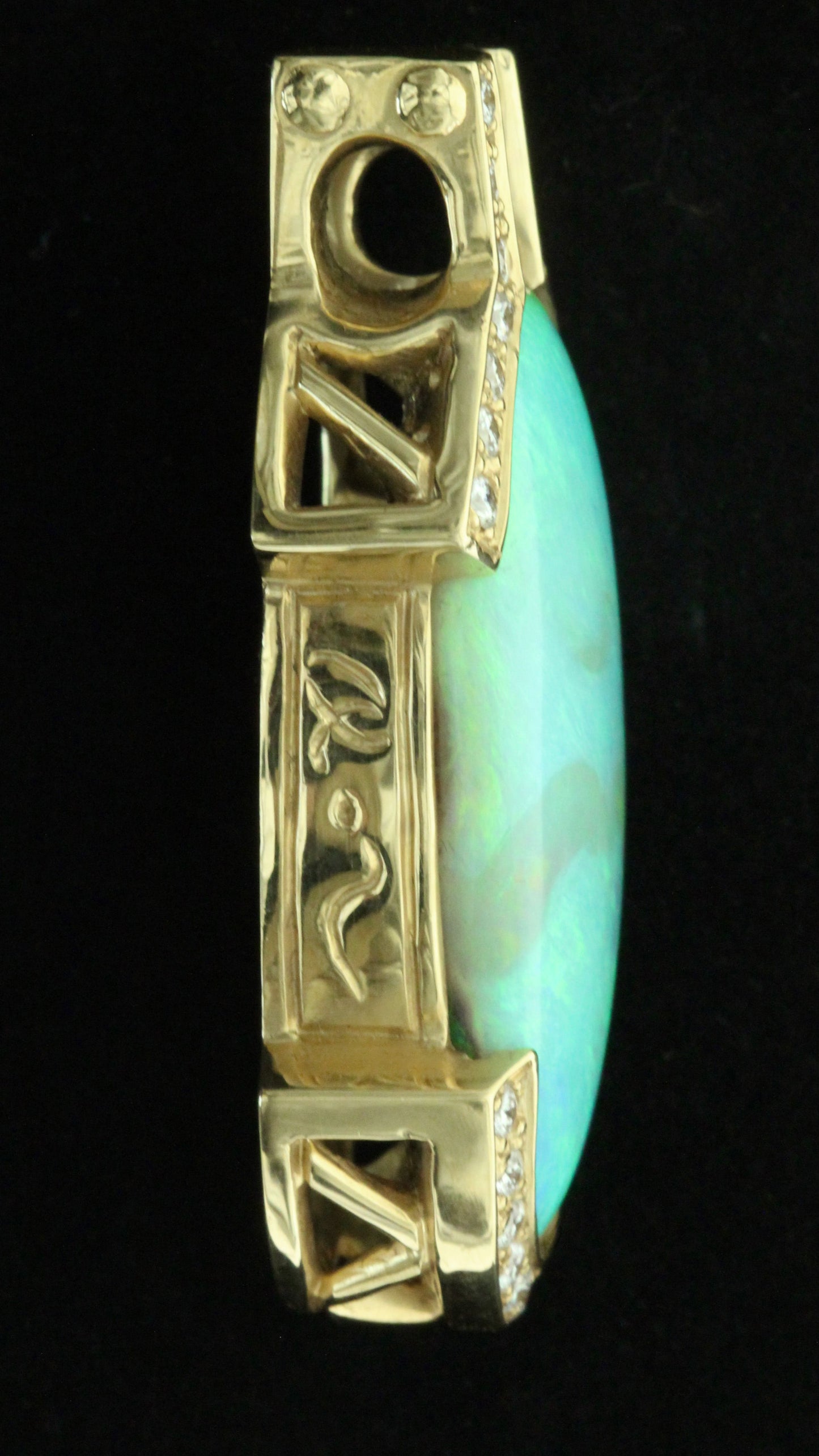 Side profile of 36ct Lightning Ridge opal pendant showing engraved 18ct yellow-gold bail and diamond shoulders.