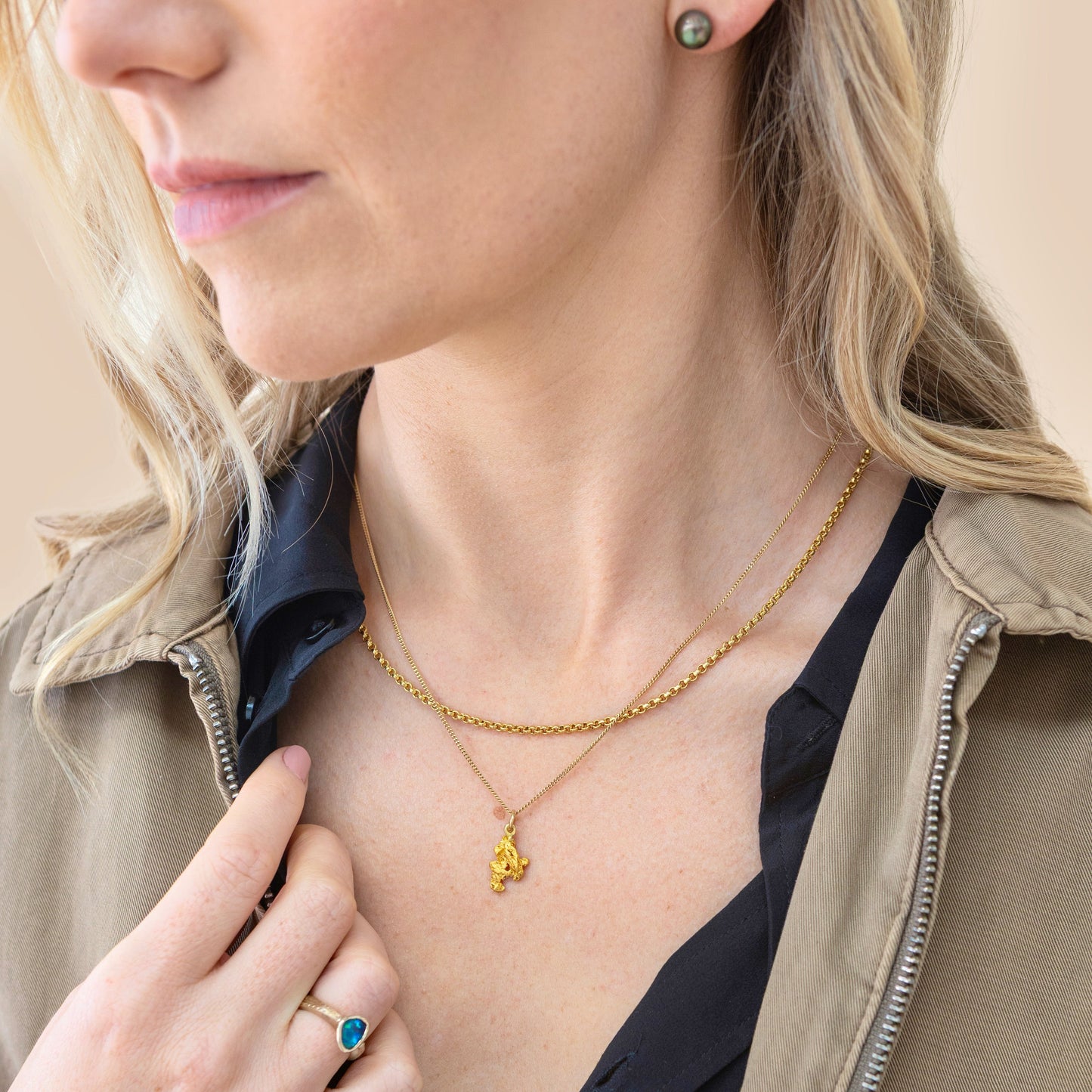 On-model image showing natural Palmer River gold nugget pendant layered with a second gold chain, chest view for size reference.