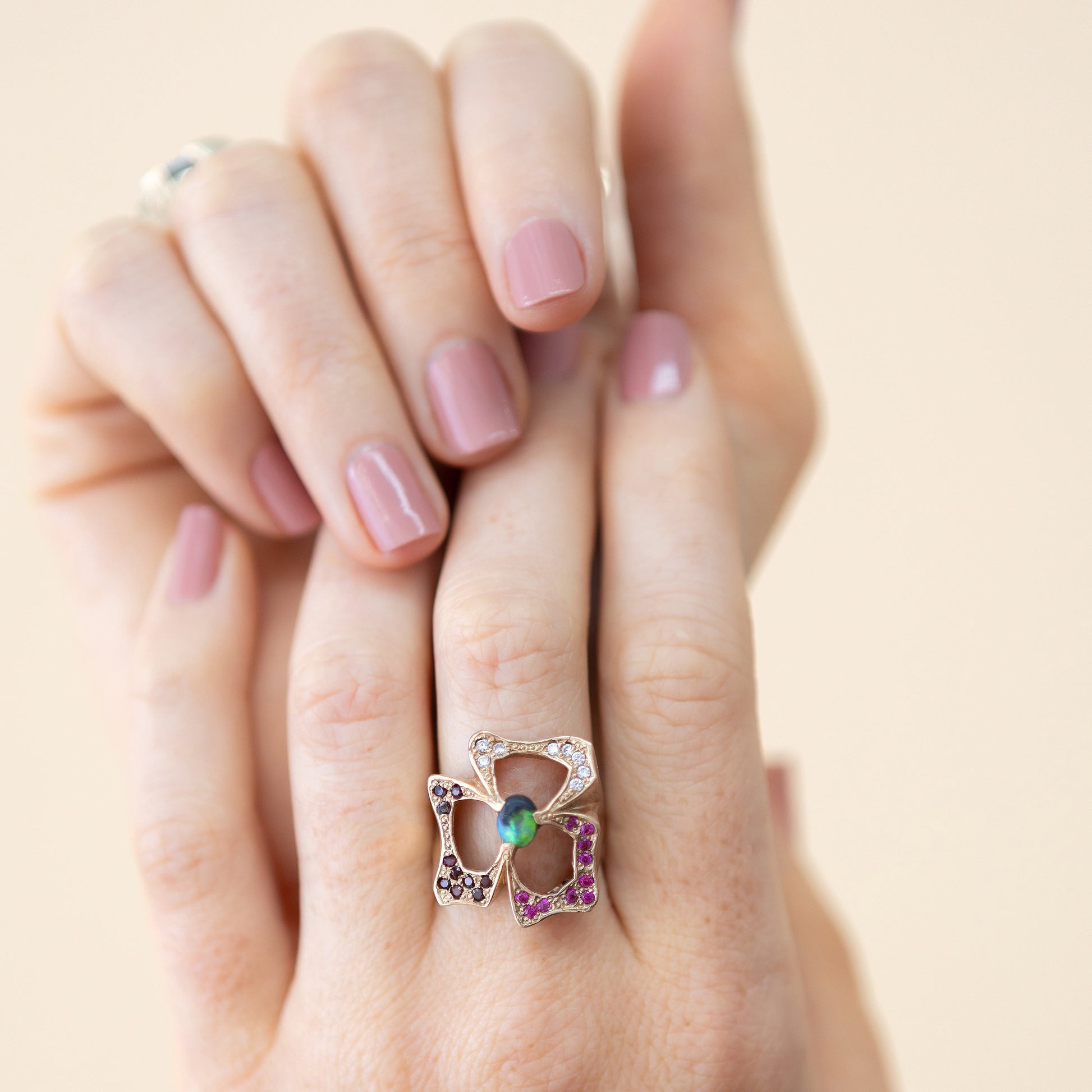 Model wearing the 0.50ct Lightning Ridge black opal, garnet and sapphire statement ring in 14ct yellow gold.
