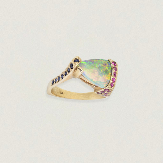Triangular Lightning Ridge opal ring with sapphire accents in 14ct yellow gold, three-quarter view on white.