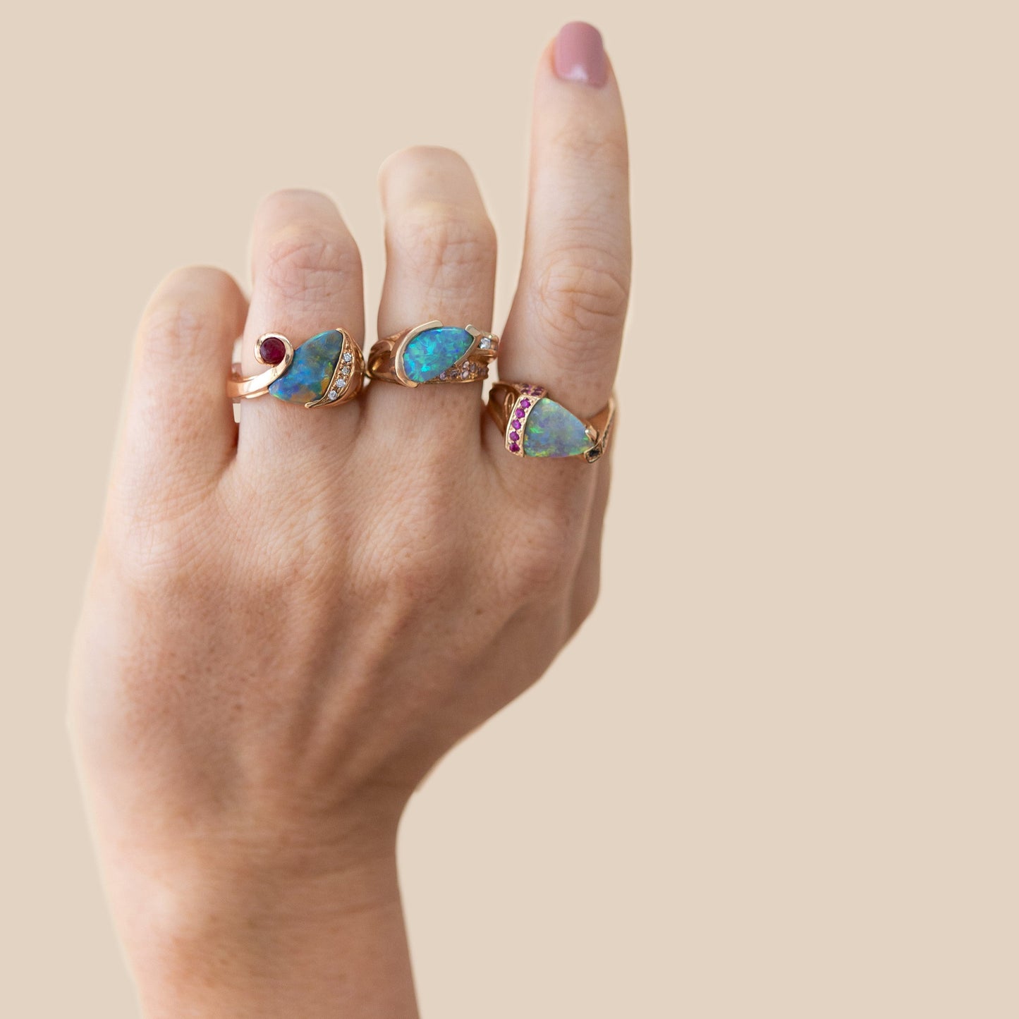 Opal and sapphire statement ring in 14ct yellow gold shown on hand for scale.