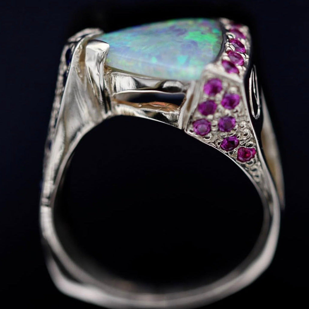 Close-up side view showing pink sapphire pavé and gallery detailing.