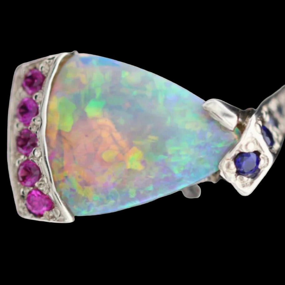 Macro of triangular opal with pink sapphire end cap and blue sapphire claw setting.