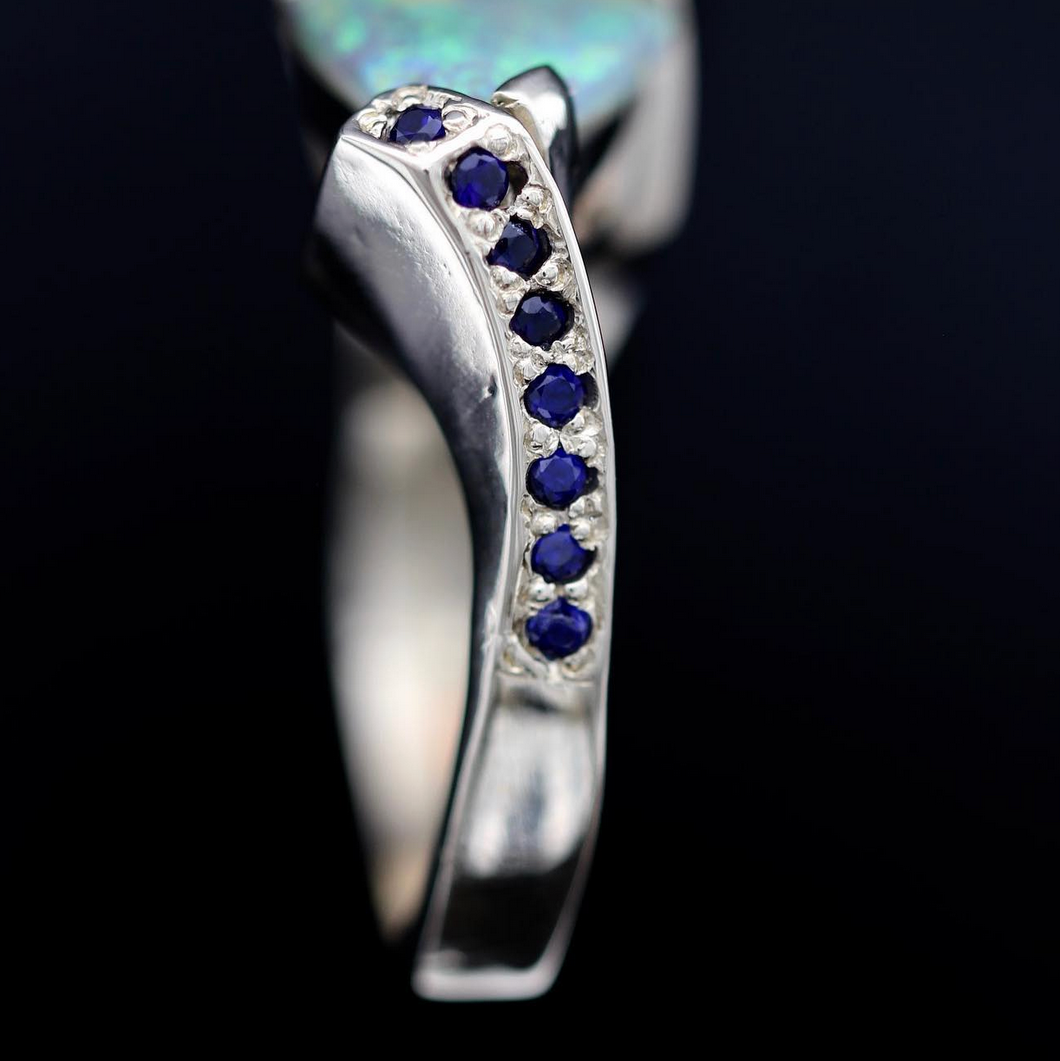 Profile of band with channel-set blue sapphires and polished 14ct gold shank.