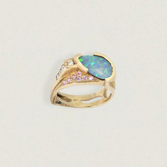 Pear-cut Lightning Ridge opal ring with diamond and pink sapphire accents in 14ct yellow gold on a clean white background.