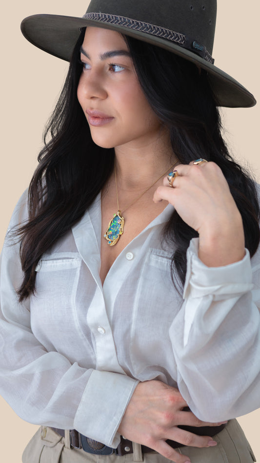 Model wearing the 19ct Lightning Ridge black opal leaf pendant in 18ct yellow gold.