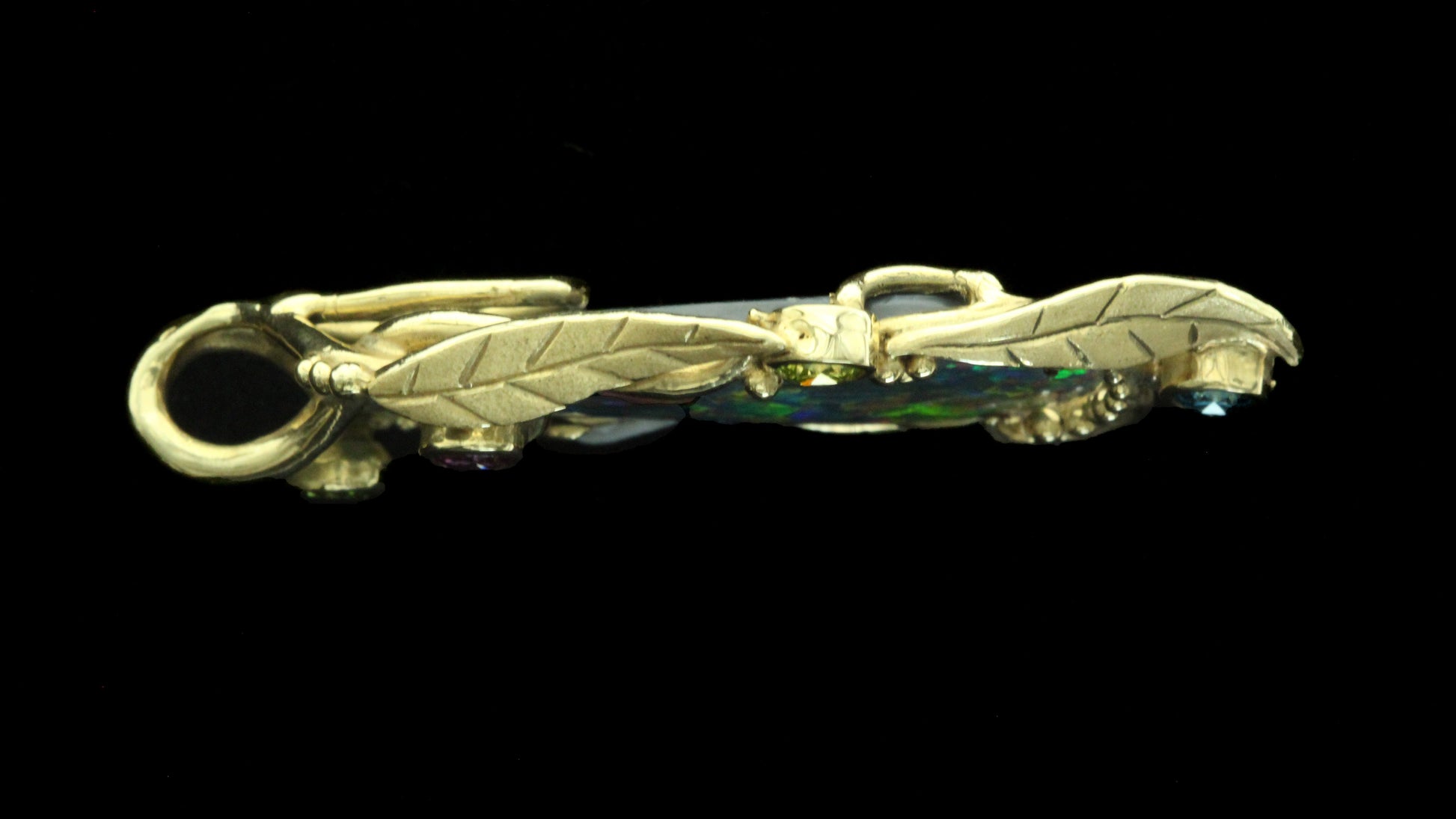 Side profile showing the pendant’s depth, sculpted leaf gallery and hidden double bail.