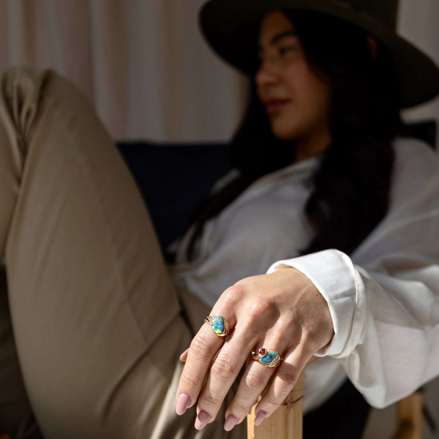 Macro of Lightning Ridge black opal cabochon with adjacent diamond cluster in an 18ct yellow gold statement ring.