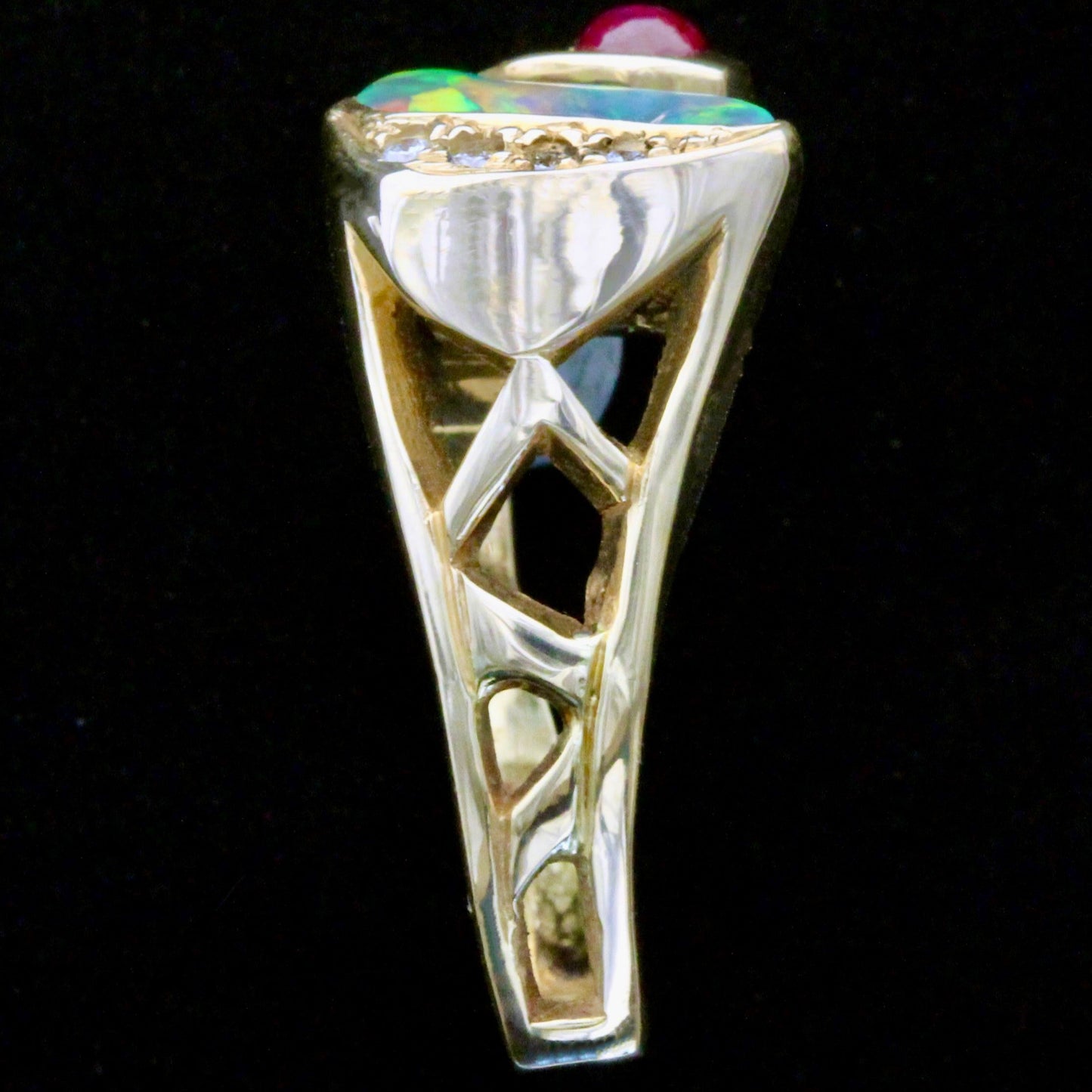 Side gallery view of 18ct yellow gold ring shank and openwork beneath opal and ruby.