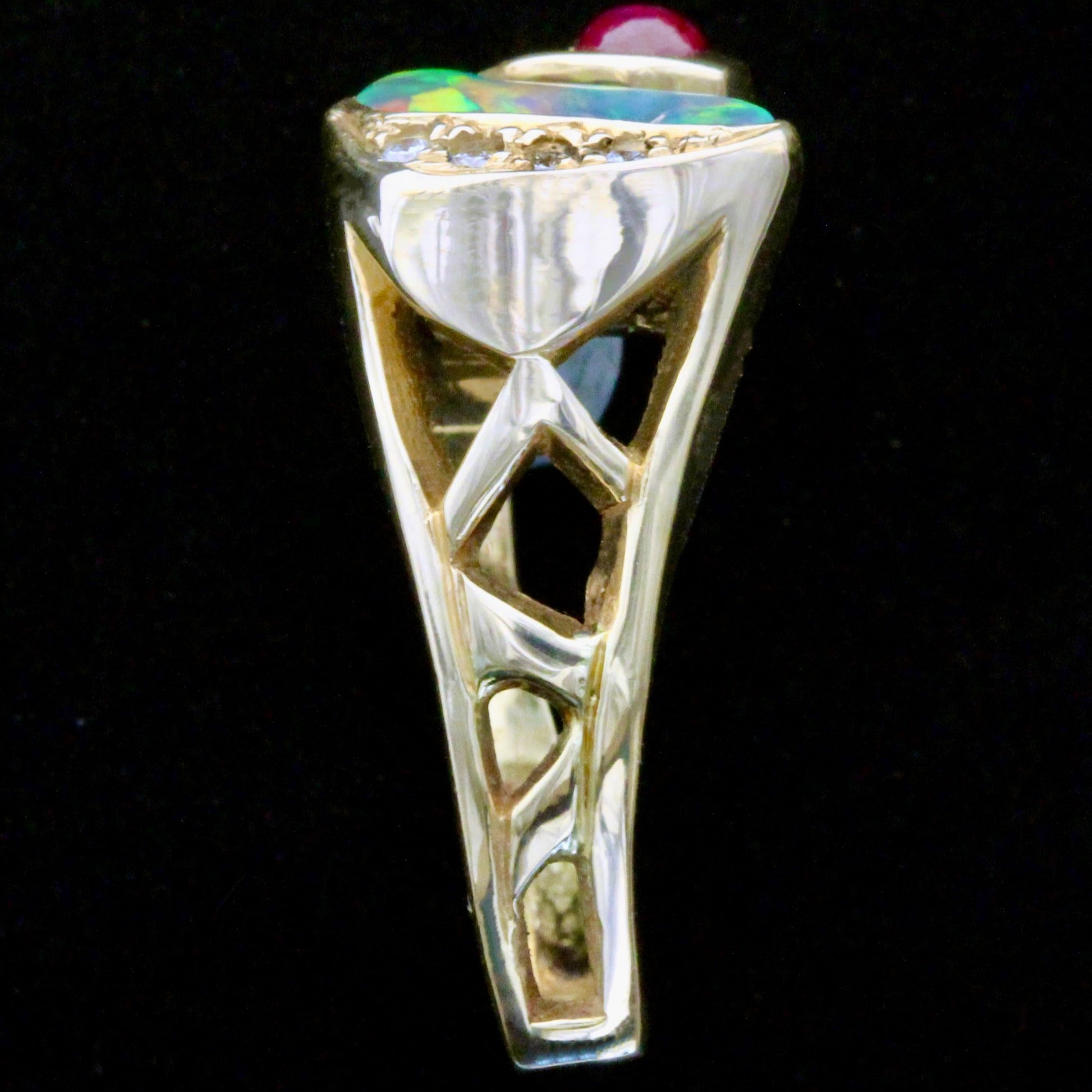 Side gallery view of 18ct yellow gold ring shank and openwork beneath opal and ruby.