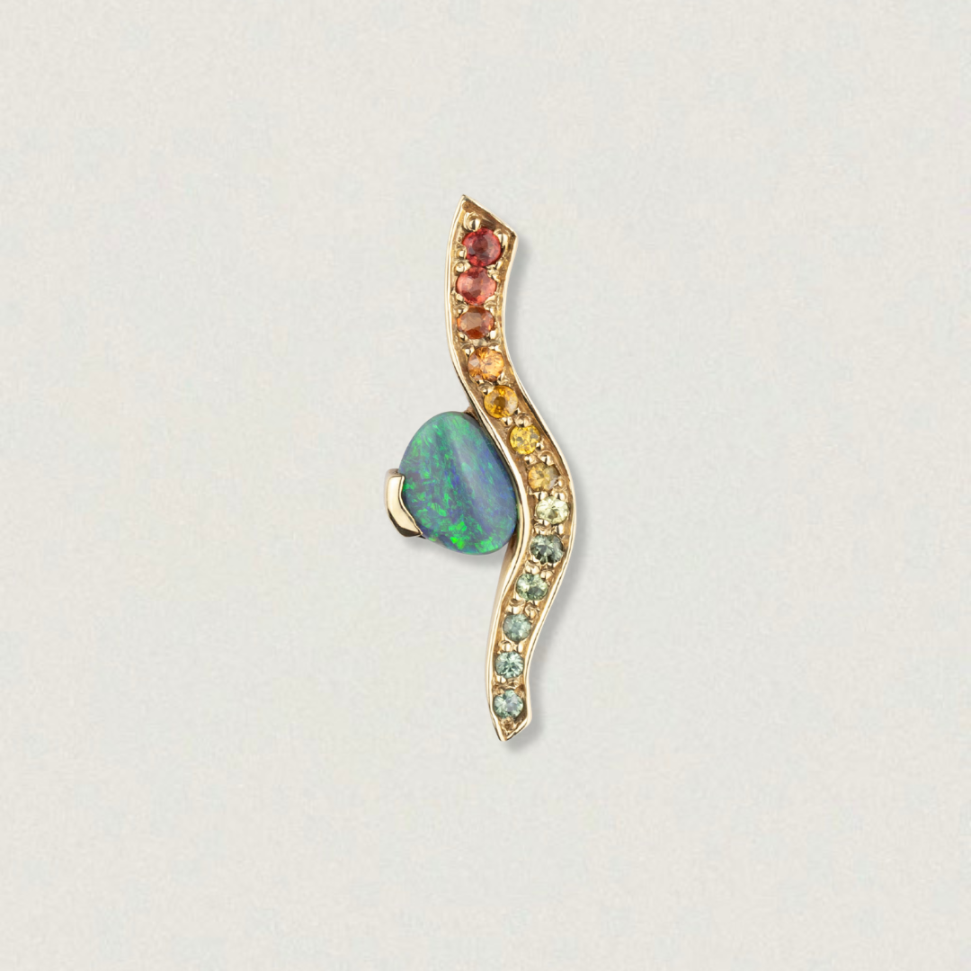Studio image of a 2ct Lightning Ridge opal and rainbow sapphire wave pendant in 14ct yellow gold.