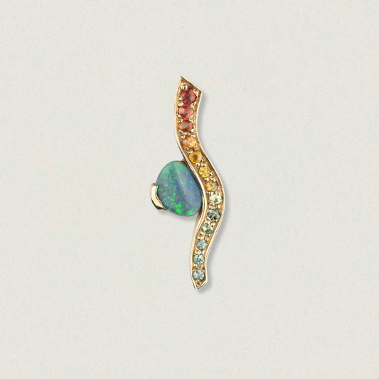 Studio image of a 2ct Lightning Ridge opal and rainbow sapphire wave pendant in 14ct yellow gold.
