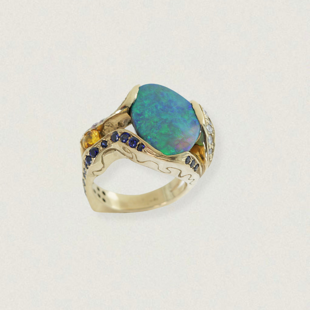 5.85ct Lightning Ridge opal, sapphire and diamond cocktail ring in 18ct yellow gold — front three-quarter product view on light background.
