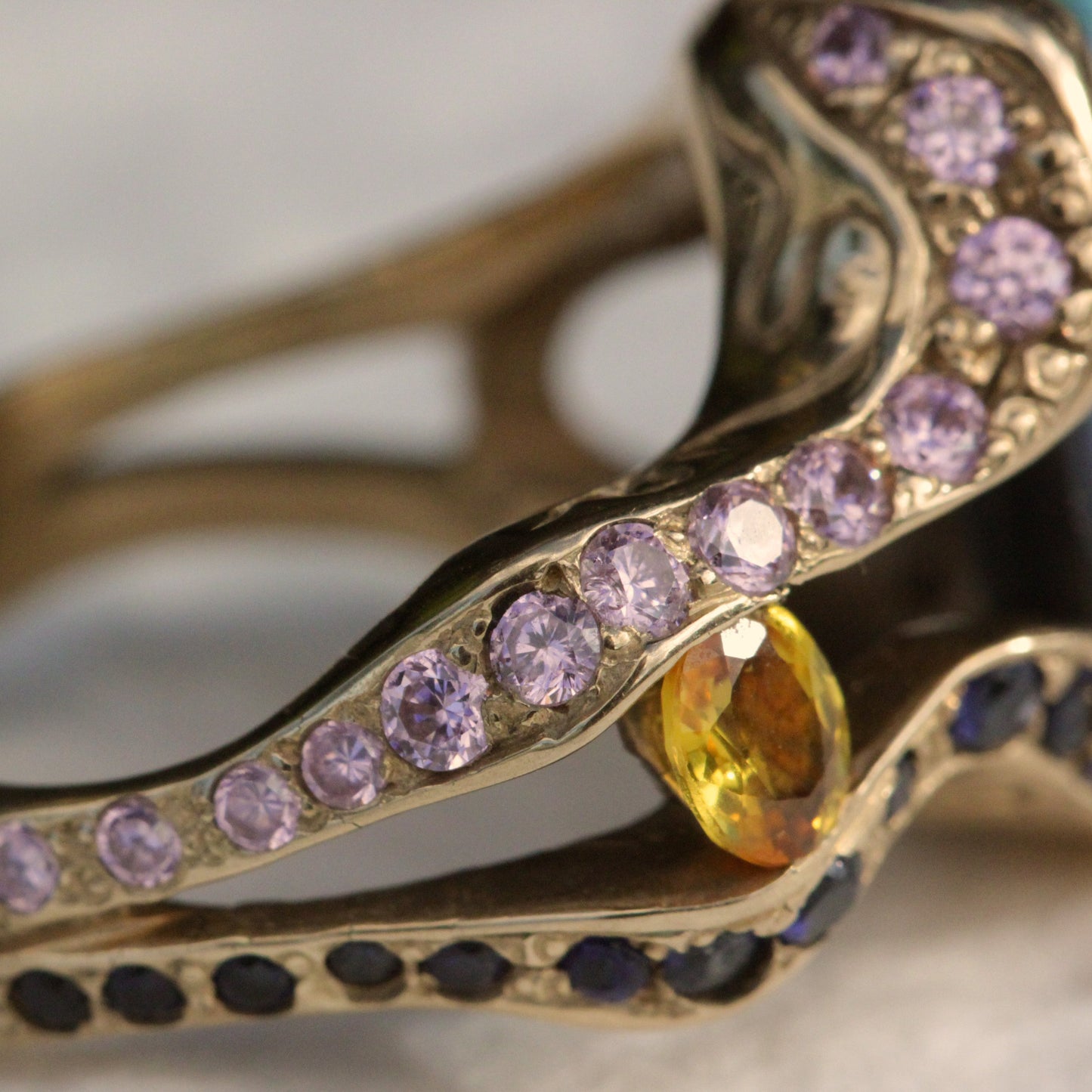 Detail of diamond-set shoulder and bezel around the Lightning Ridge opal on the 18ct yellow gold cocktail ring.