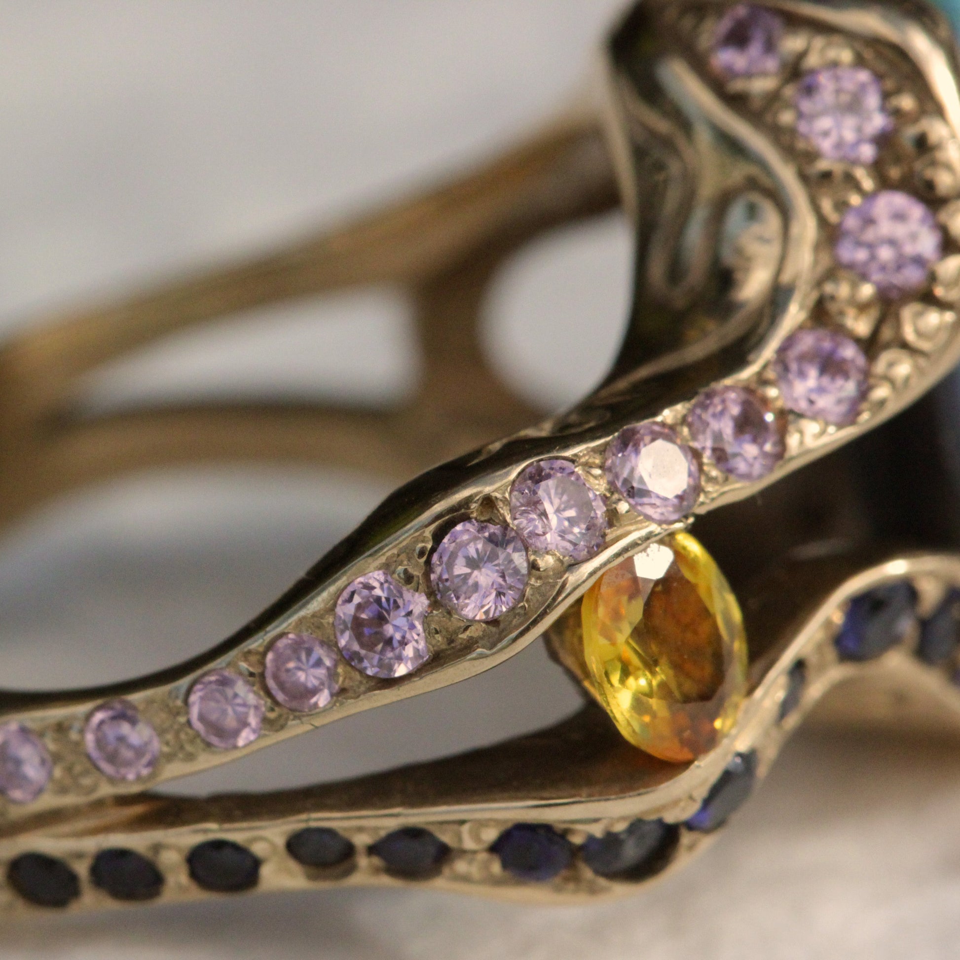 Detail of diamond-set shoulder and bezel around the Lightning Ridge opal on the 18ct yellow gold cocktail ring.
