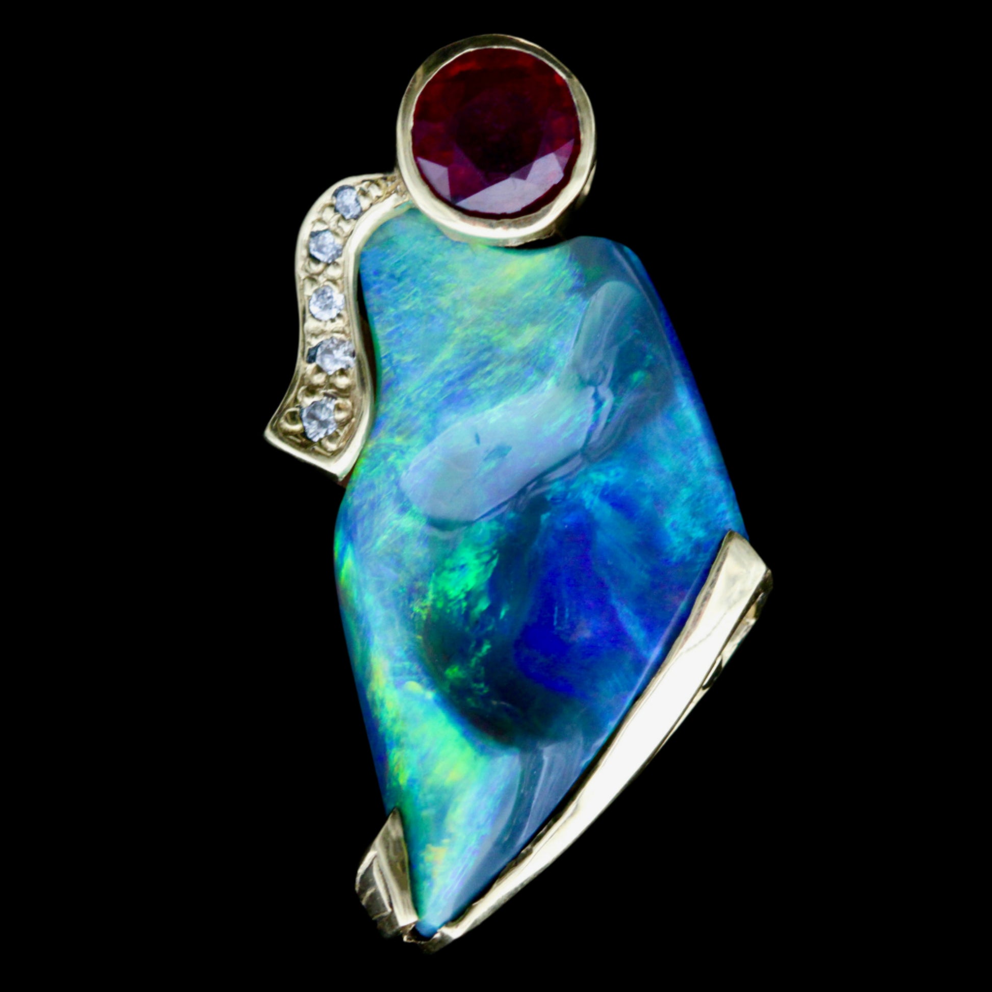 Close-up of vivid blue-green Lightning Ridge opal with round ruby and pavé diamond accent in 14ct yellow gold.