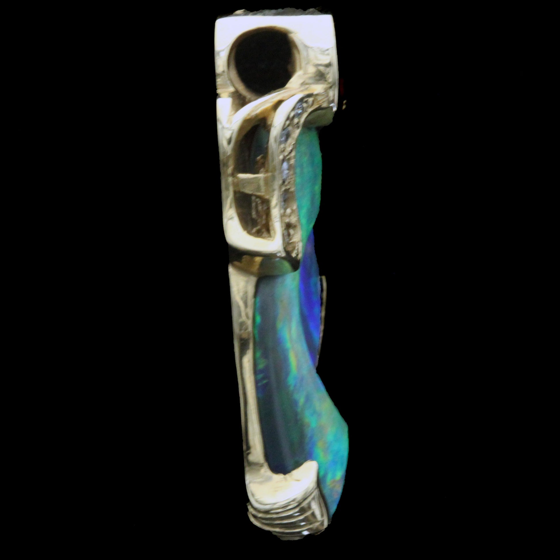 Right side profile of the pendant showing sculpted gold and opal thickness.