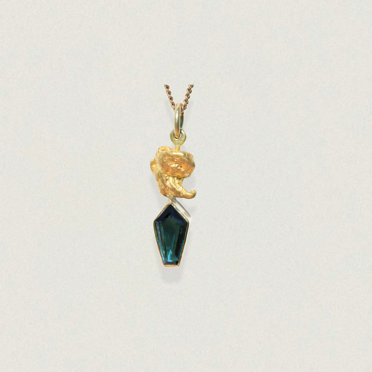 Australian parti sapphire kite-cut pendant topped with a natural gold nugget, shown on chain against a light background.