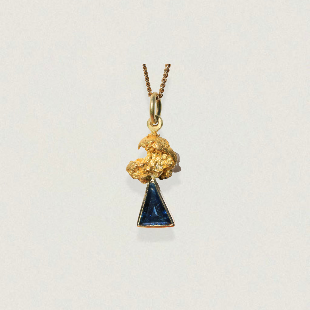 Australian parti sapphire triangle pendant capped with a natural gold nugget (92–98% pure gold) on a fine chain, on a light background