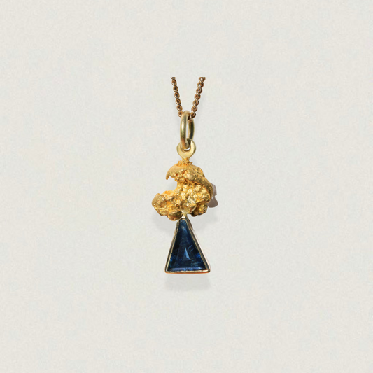 Australian parti sapphire triangle pendant capped with a natural gold nugget (92–98% pure gold) on a fine chain, on a light background