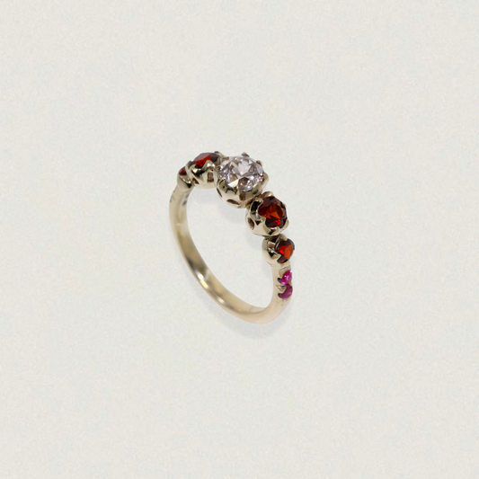 Handmade five-stone heirloom ring featuring a 1.5 ct colour-change zircon with garnet and pink sapphire accents.