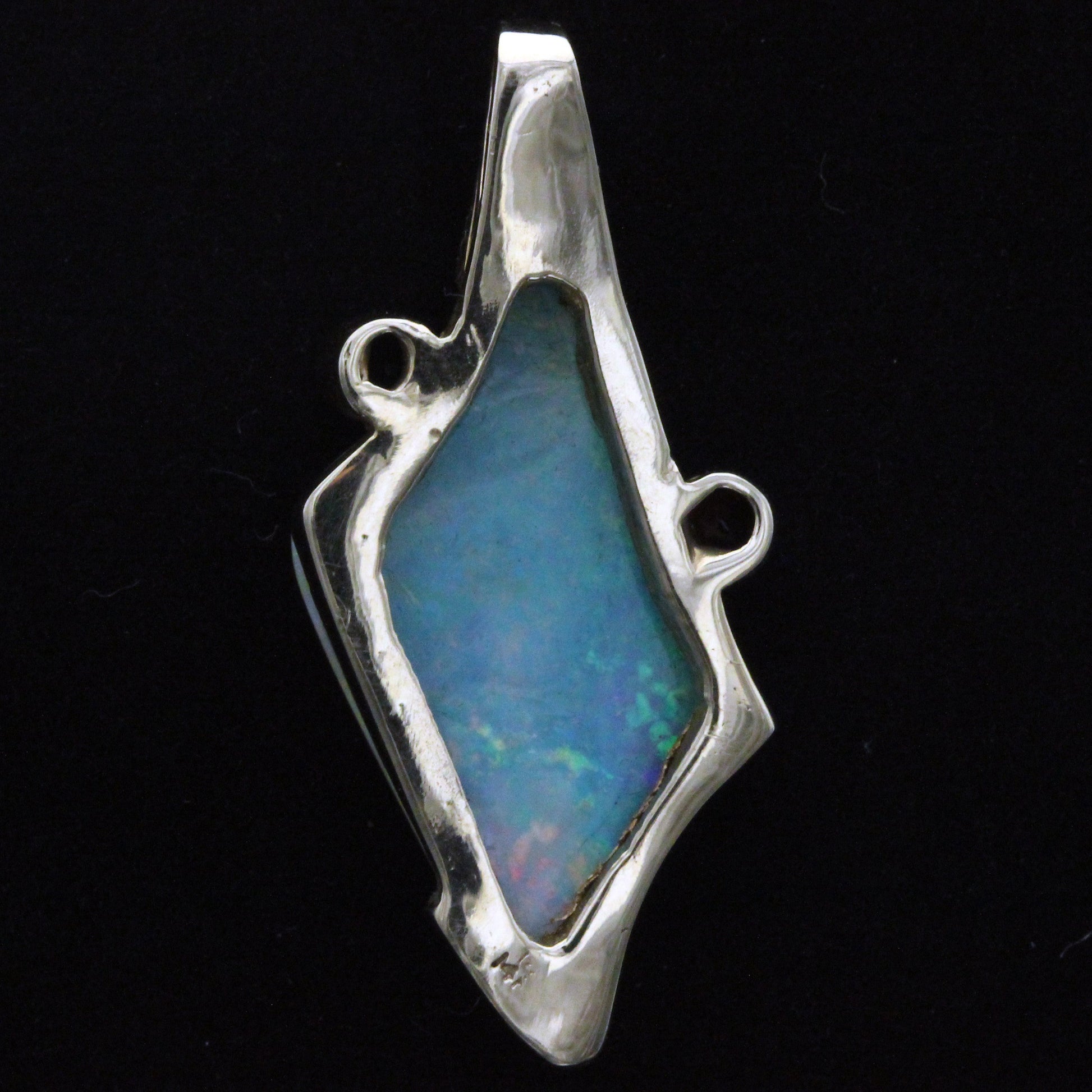 Back view of the Lightning Ridge crystal opal pendant showing the gallery and settings behind the opal and accent sapphires