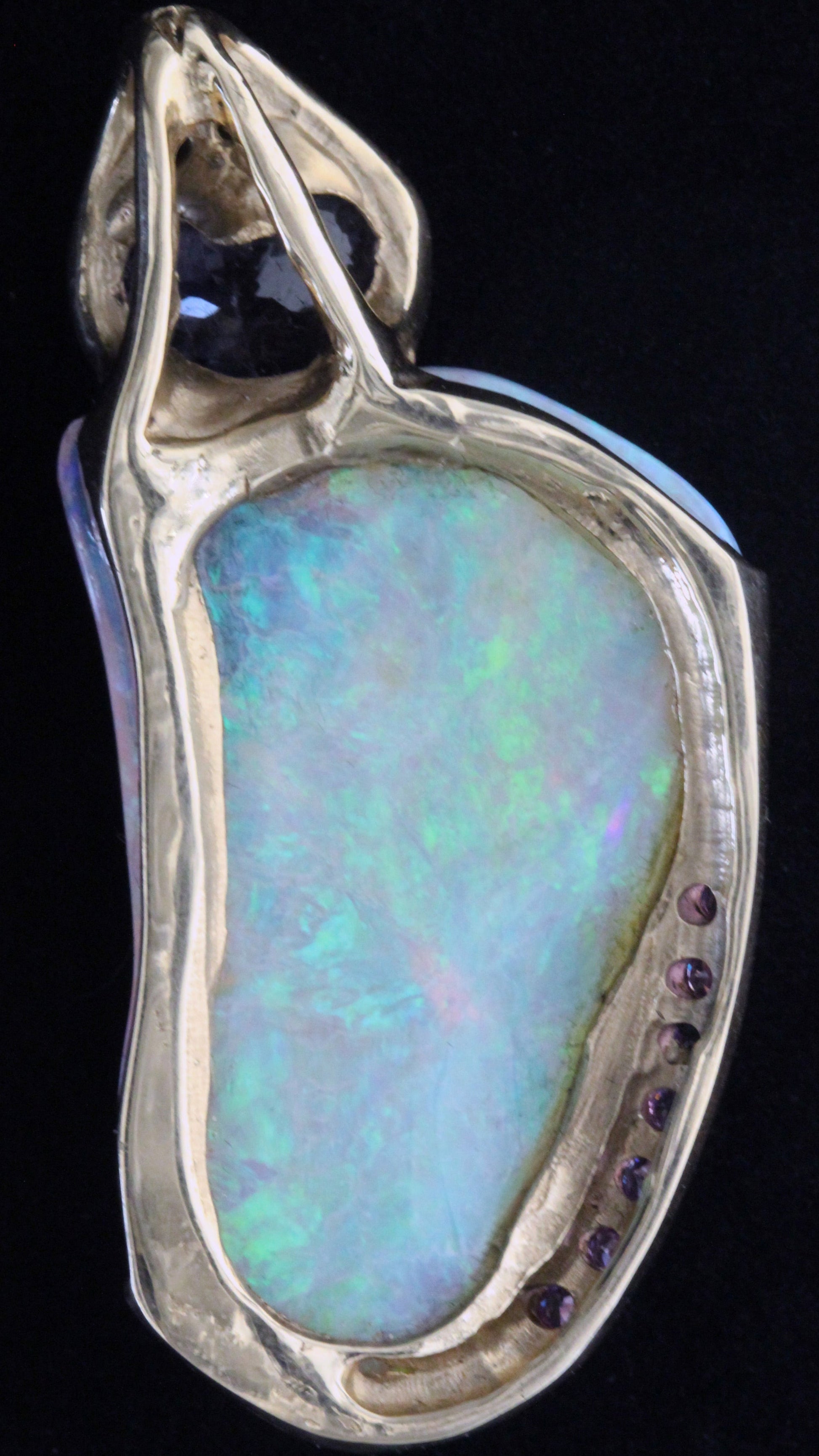 Back view of Lightning Ridge crystal opal pendant showing yellow-gold gallery and pavé sapphire detailing.