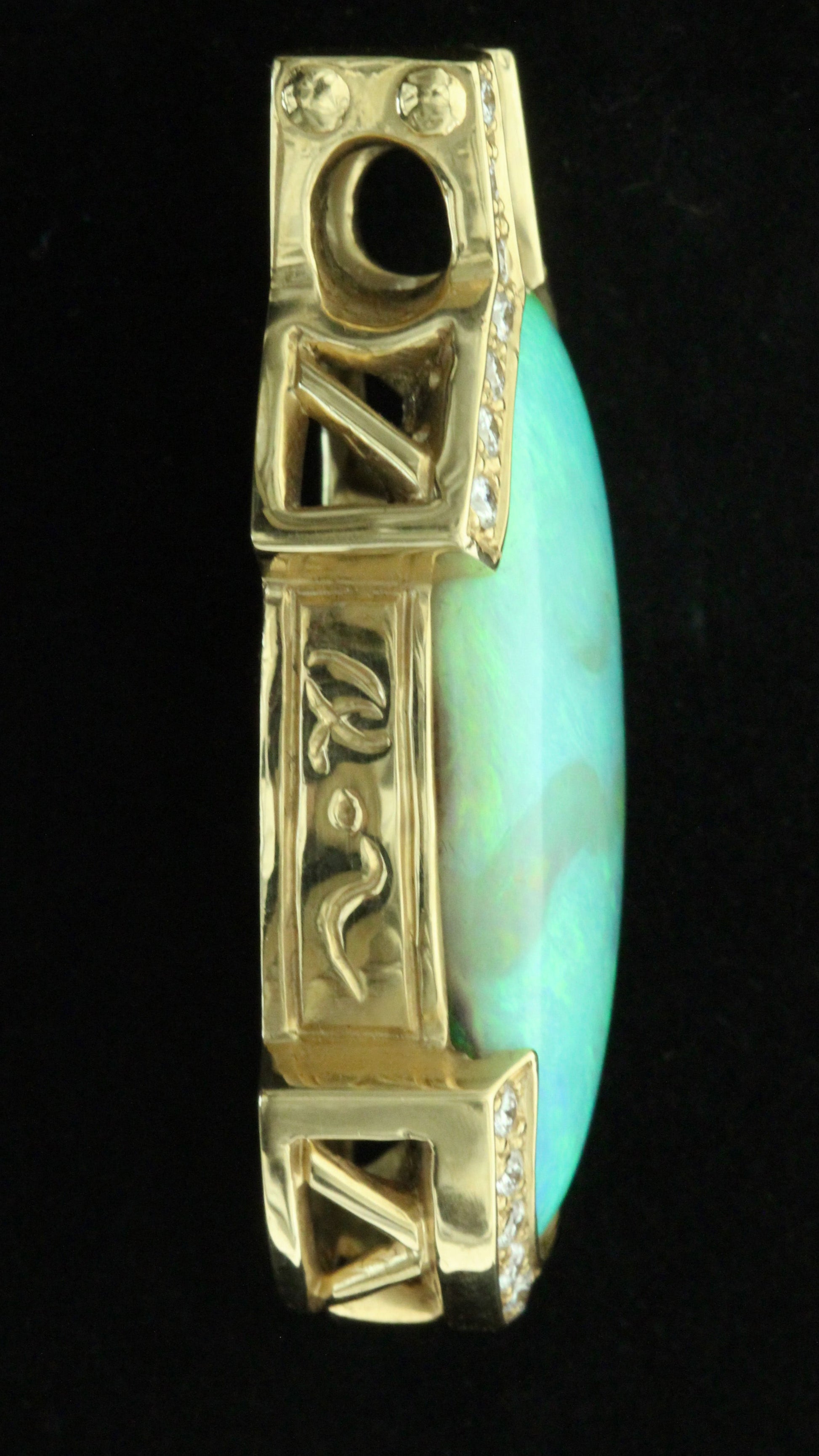 Side profile of 36ct Lightning Ridge opal pendant showing engraved 18ct yellow-gold bail and diamond shoulders.