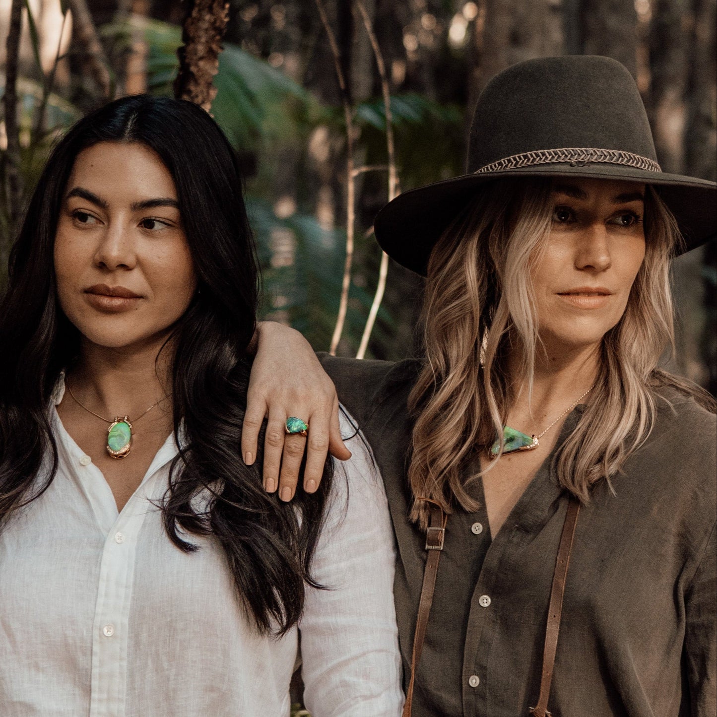 Lifestyle image showing Lightning Ridge Australian opal jewellery worn on models in a rainforest setting.