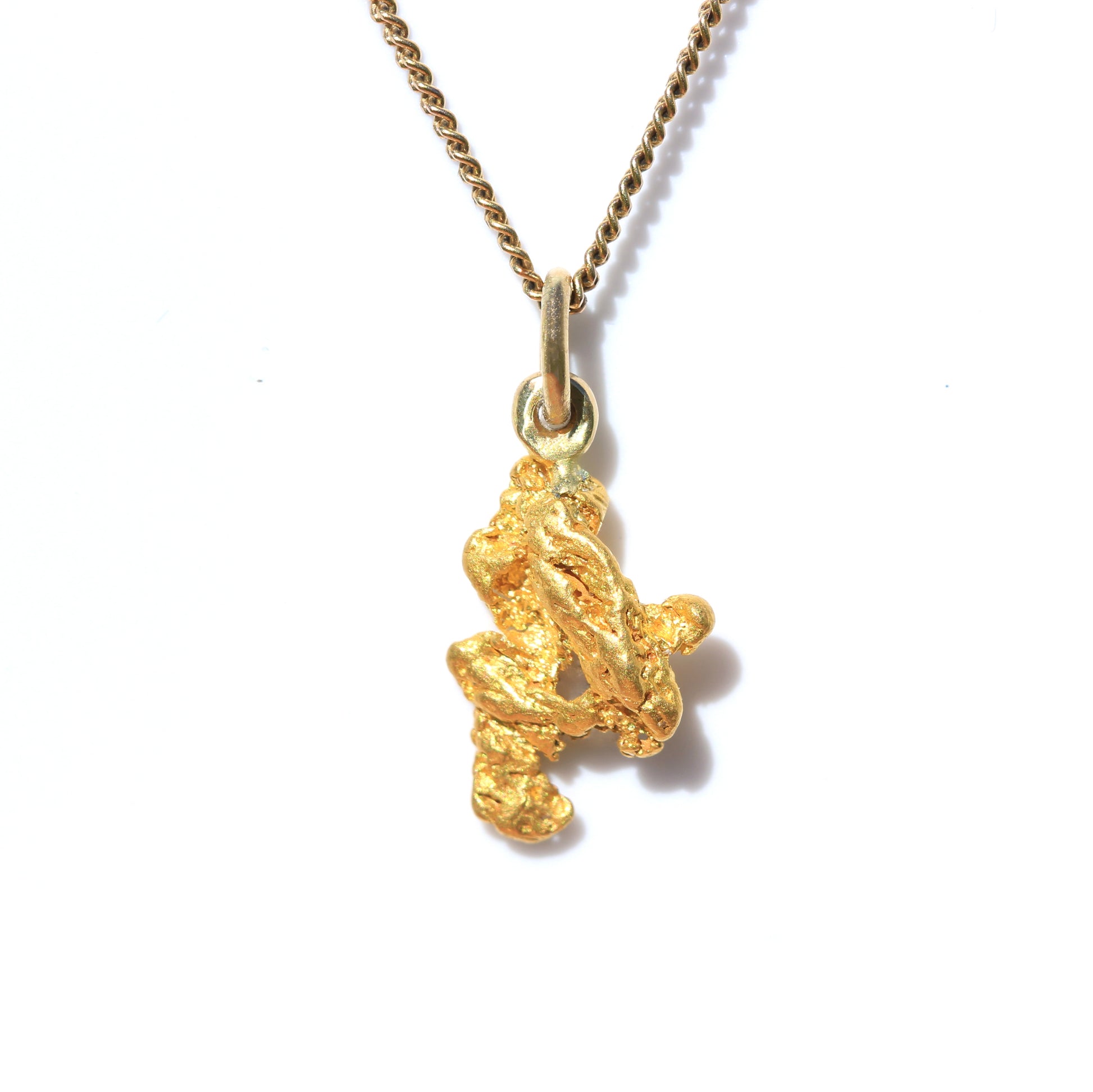 Natural Palmer River Australian gold nugget pendant on chain, front view on white background.