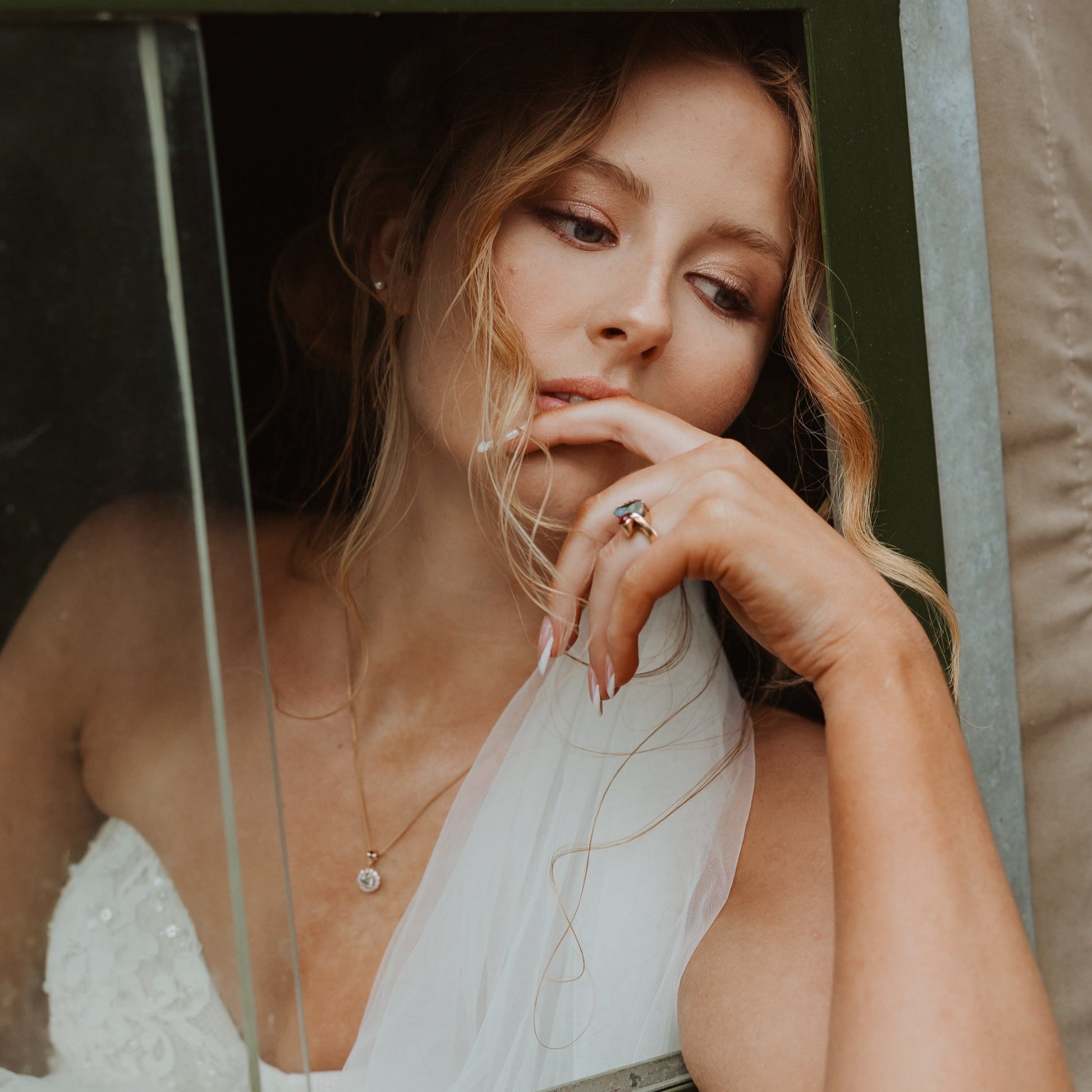 Bride wearing 1ct vintage diamond halo pendant in 14ct rose gold