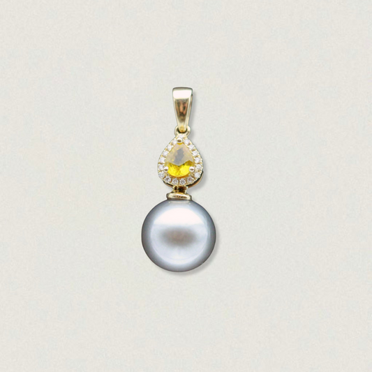 Vintage 14ct yellow gold pendant featuring a 0.45ct yellow sapphire with diamond halo above a grey Tahitian pearl, on white background.